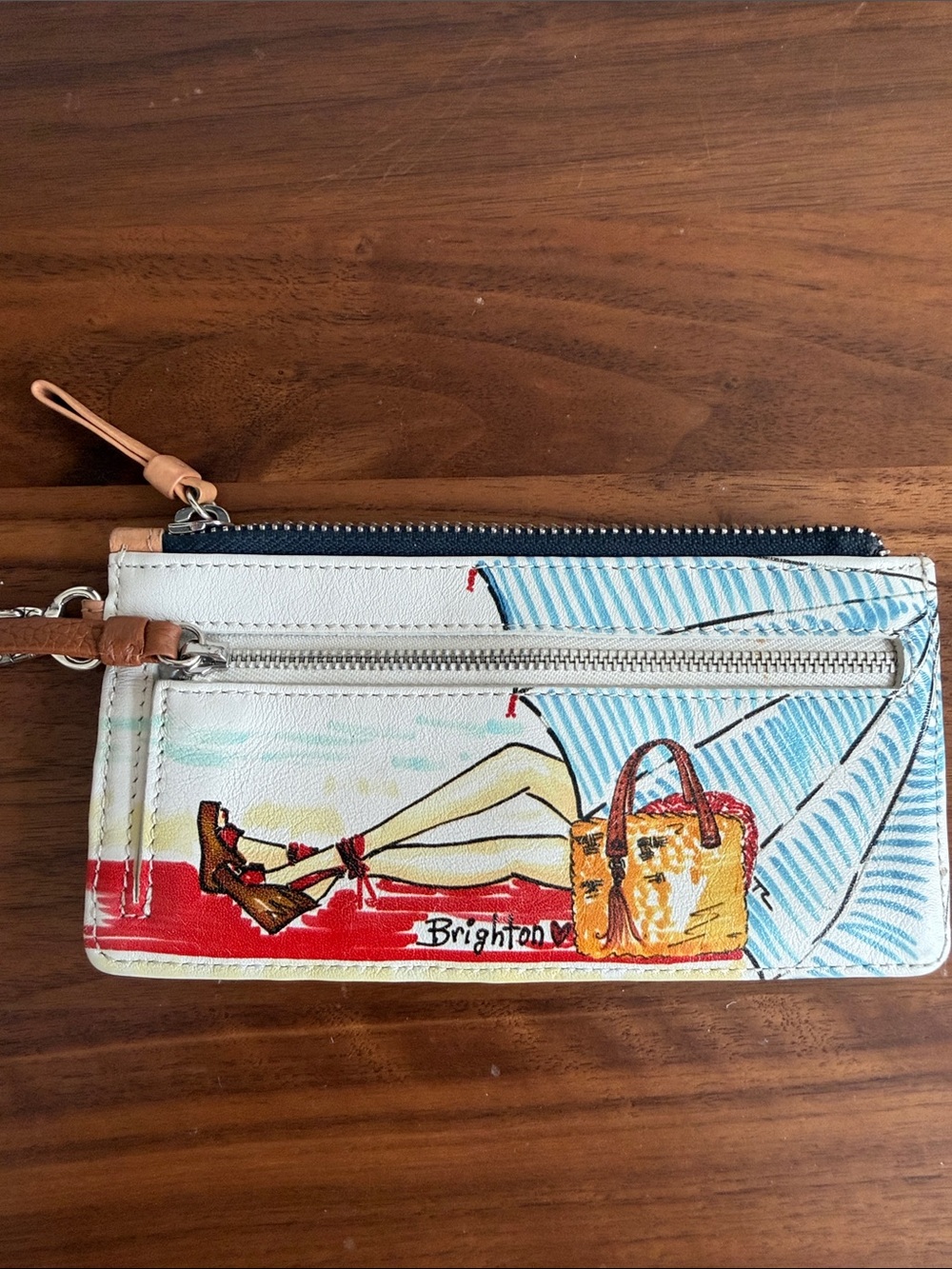 Brighton Cream Leather Fashionista Wristlet with playful beach themed graphic